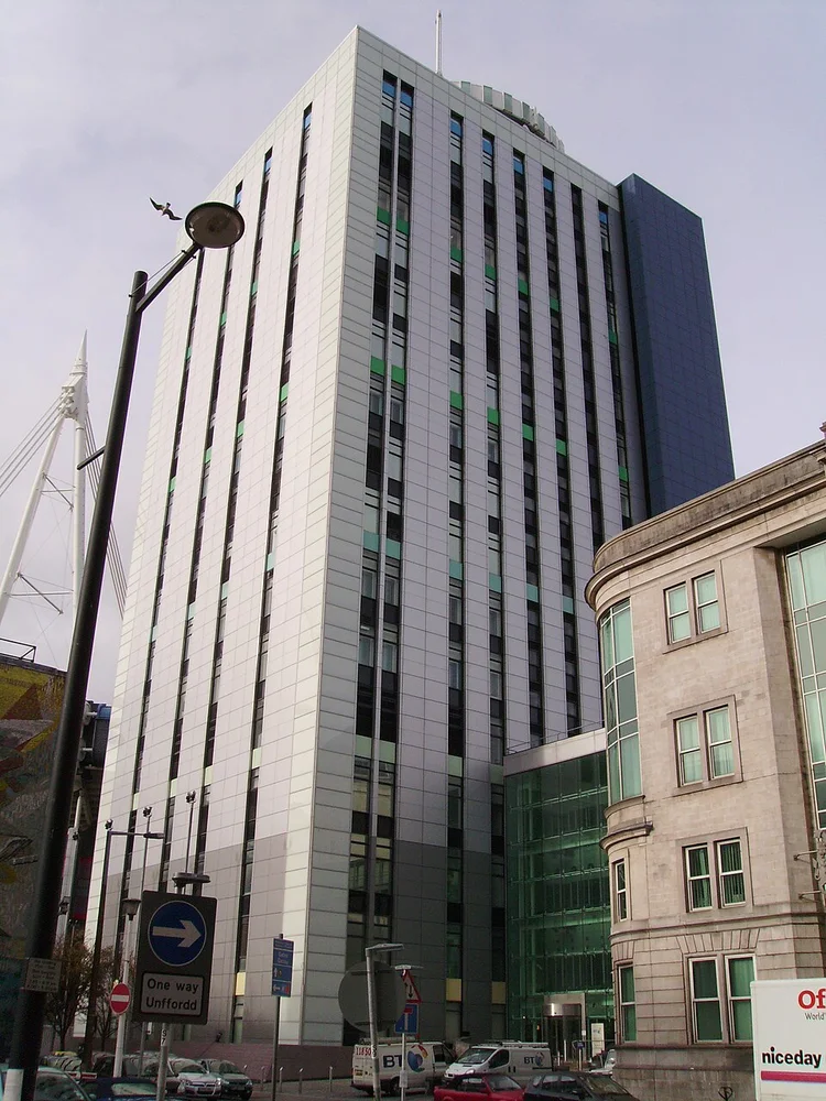 Stadium House, a tall white building with a mast, on Park Street in Cardiff.