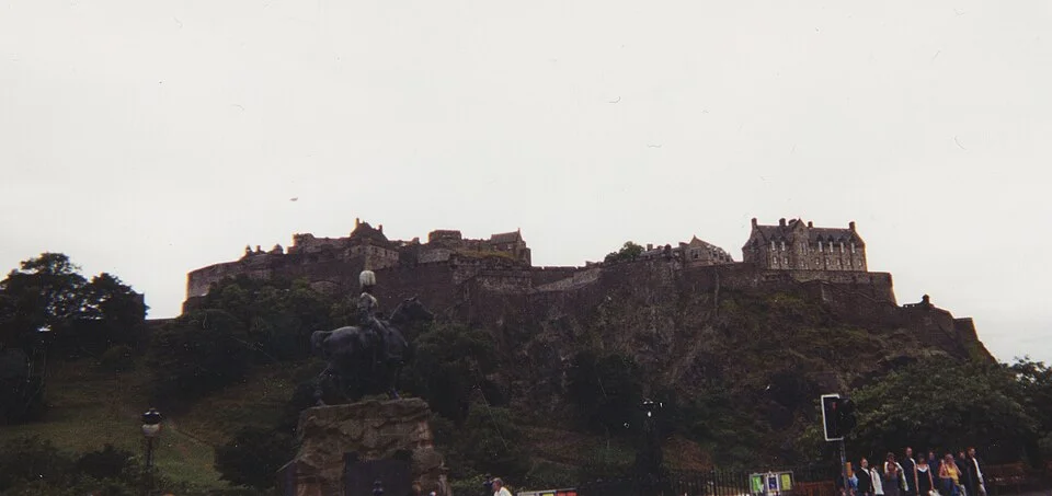 Edinburgh Castle and surrounding buildings on the rocky hill above the city.