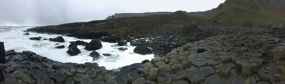 Panorama of the interlocking basalt columns and rocky coast at Giant’s Causeway in Northern Ireland.