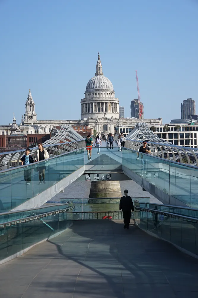 The dome of St Paul’s Cathedral in London, seen across the Thames with the Millennium Bridge in the foreground.